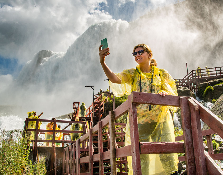A woman stands on the Hurricane Deck at Cave of the Winds in Niagara Falls State Park